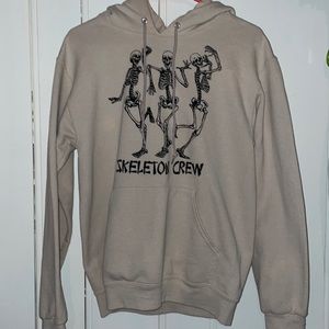 Small woman’s cream colored hoodie with a Halloween design on it.